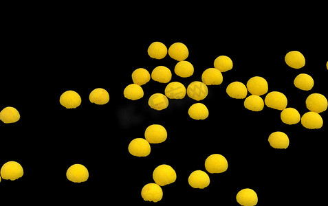 黄色荧光球体摄影照片_黑色背景上的亮黄色球体