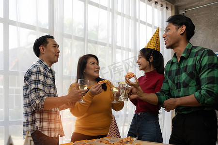 一群亚洲朋友在家里聚会时吃披萨。