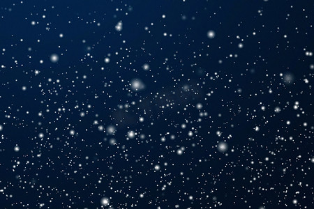 寒假和冬季背景，白雪落在深蓝色背景上，雪花散景和降雪颗粒作为圣诞节和下雪假期设计的抽象下雪场景
