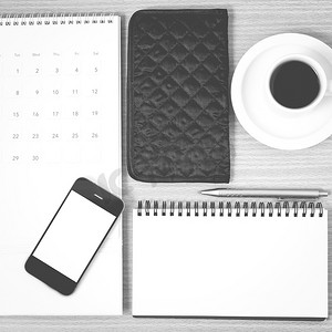 电脑桌面日历摄影照片_桌面：带电话的咖啡、记事本、钱包、日历黑色和白色