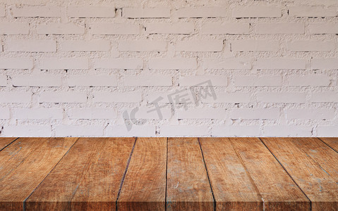 白色砖墙摄影照片_有白色砖墙的棕色木桌面