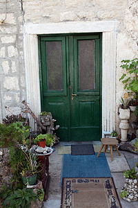 黑山 Prcanj 的带绿色门和鲜花的地中海房屋