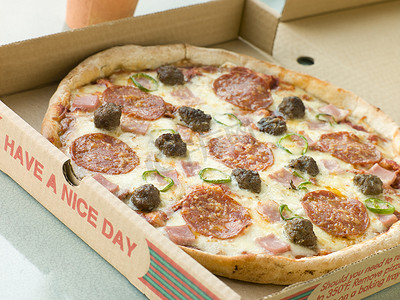 外卖零食摄影照片_外卖盒中的肉盛宴披萨