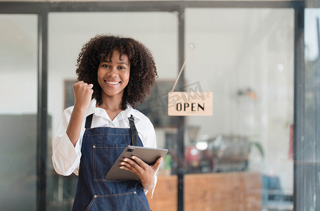 创业成功的小企业主 sme 美女站在咖啡店餐厅与平板智能手机。