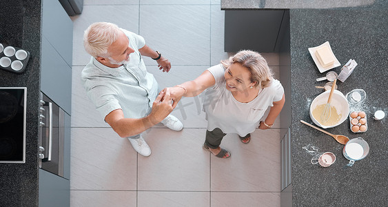 顶视图舞蹈和厨房里的老年夫妇一起玩乐、结合和享受退休生活。