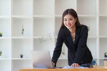 财务报告摄影照片_在家办公室工作的亚洲女商人分析财务报告文件。