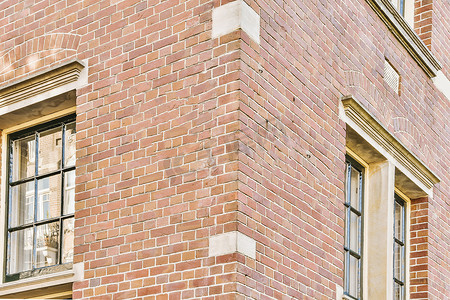 带窗户的砖墙摄影照片_一栋带窗户的建筑物的砖墙