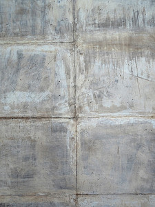 混凝土划痕摄影照片_方形块的混凝土灰色划痕墙。