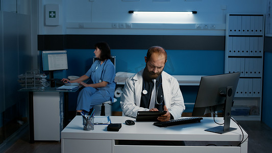 白种人医生手持平板电脑寻找患者疾病专业知识