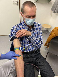 戴手套的护士摄影照片_戴蓝色手套的护士、医生或医疗技术人员正在采集血样