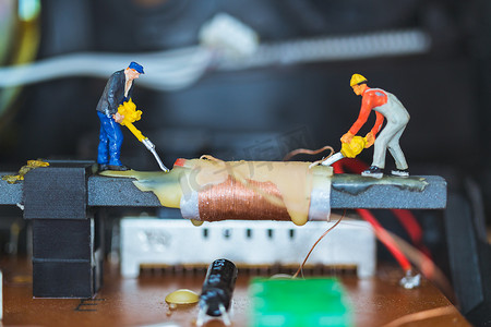 微型人：维修电子电路的工人团队。