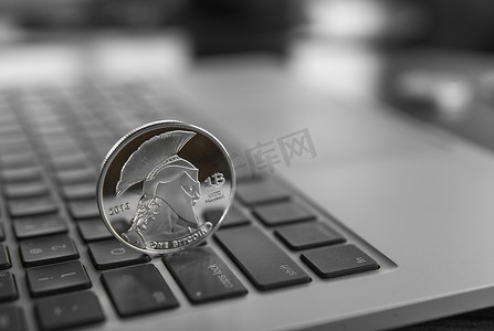 笔记本电脑键盘上的银泰坦加密硬币。