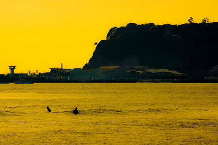 冲浪者剪影和黄昏的镰仓海岸