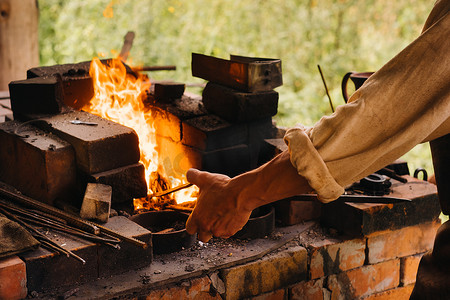 铁匠在村里自制的炉子里用高温硬化钢材