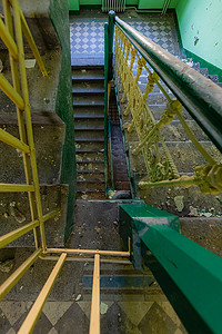 绿色矩形摄影照片_旧废弃建筑中旧矩形螺旋楼梯的顶视图