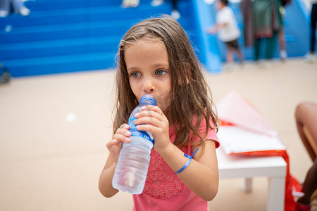 儿童从户外塑料瓶喝水