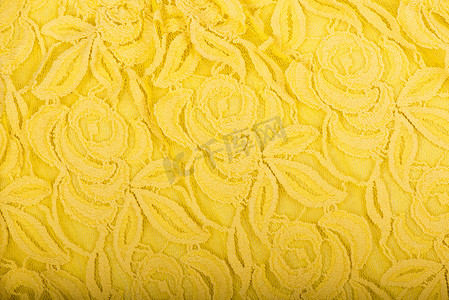 帆布背景，金黄色织物纹理背景，花边图案细节。