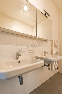 洗马桶摄影照片_带两个水槽和一面镜子的白色浴室