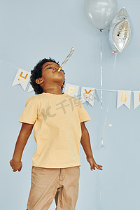 快乐的非洲裔美国小孩在生日派对上在室内玩得开心