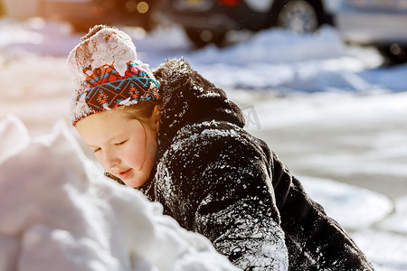 在家开车的路上下雪，小孩在雪地里在户外玩耍