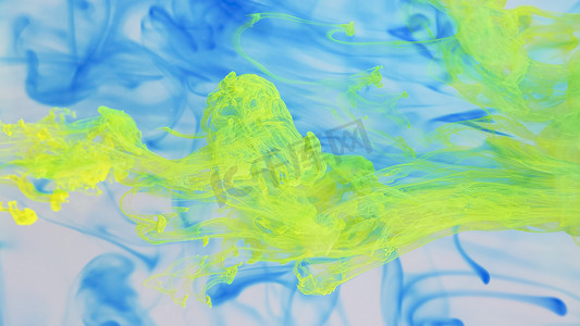 油漆滴摄影照片_溶解在水中的蓝色和黄色油漆滴。