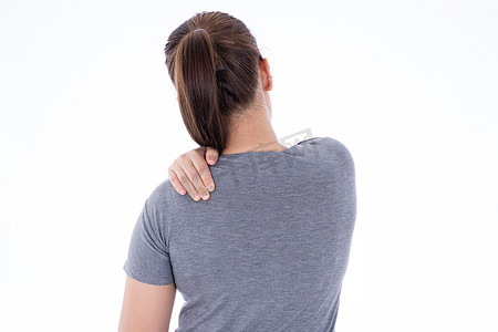 肩肌肉摄影照片_一个女人在孤立的白色背景下感到筋疲力尽，肩颈疼痛和受伤。