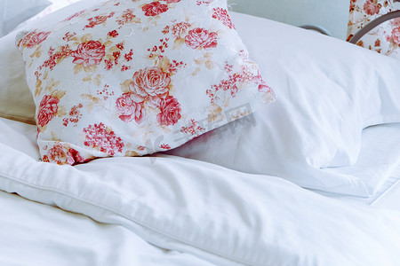 明亮的卧室内饰，床上有花卉图案枕头