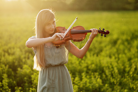 拉小提琴的头发松散的浪漫女人。