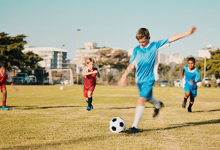 足球，夏季男孩在球场上跑步和踢球，动机和运动锻炼目标。