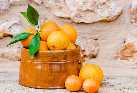 冬天水果摄影照片_水果碗里有叶子的新鲜橙子