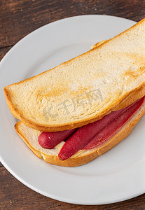 三明治摄影照片_白瓷盘上的火腿、香肠和奶酪三明治