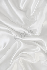 作为背景的光滑的典雅的白色丝绸
