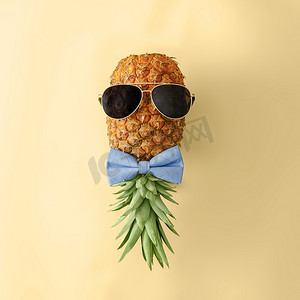 粉色菠萝摄影照片_戴着墨镜和领结的俏皮菠萝。