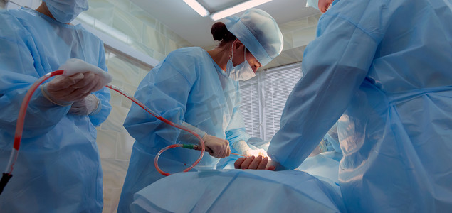 实际手术室环境中的美容吸脂手术显示外科医生的手和插管