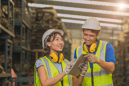 亚洲青年男女工人团队工程师一起工作帮助支持使用平板电脑快乐的微笑在工厂工作。