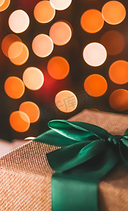 大气礼物盒摄影照片_节日气氛和节日气氛、包裹的礼物和圣诞树灯在背景