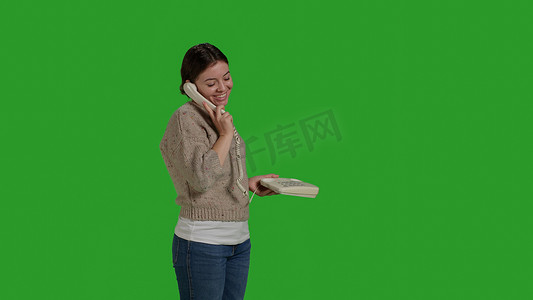 快乐女孩在座机电话上聊天的侧视图
