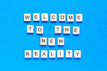蓝色背景上用木字写的欢迎来到新现实的题词。
