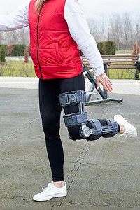 在公园锻炼腿部手术后戴护膝或矫形器的妇女