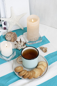 学习休息：条纹桌布上放着一杯热红茶和自制饼干；