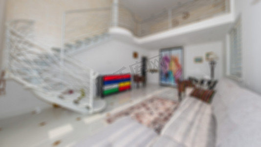 两层室内设计中现代豪华舒适独特客厅的散焦和模糊抽象照片。