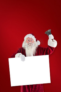 摇铃铛摄影照片_圣诞老人的复合形象举着牌子，摇响了他的铃铛