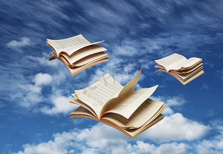 三本打开的书在蓝天上飞翔