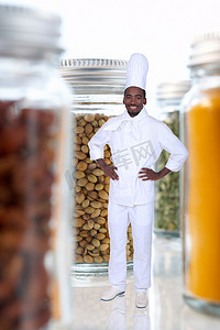 黑人厨师摄影照片_黑人厨师在装满食品的巨型罐子中