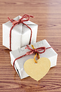 标签背景摄影照片_有心脏标签卡片的棕色礼物盒