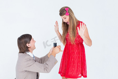 膝盖弯曲摄影照片_赶时髦的人在弯曲的膝盖上向他的女朋友求婚