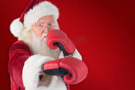 红拳摄影照片_圣诞老人用他的右拳的合成图像