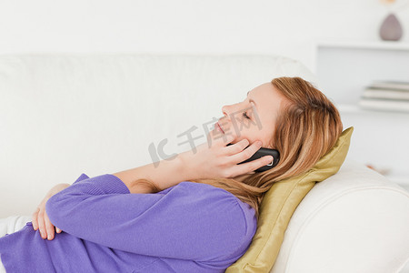 一个安静的红发女人躺在电话里的侧面肖像