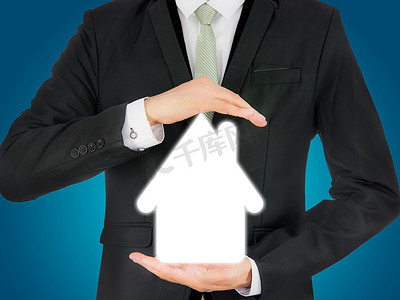 商人站立姿势手拿着孤立的房子图标