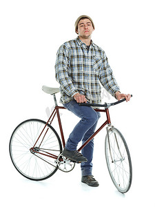 刹车踏板摄影照片_年轻人在白色的固定齿轮自行车上玩把戏